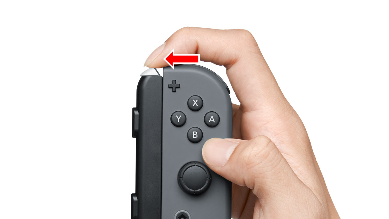 Use your finger to move the Joy-Con AA battery pack release button to the side.