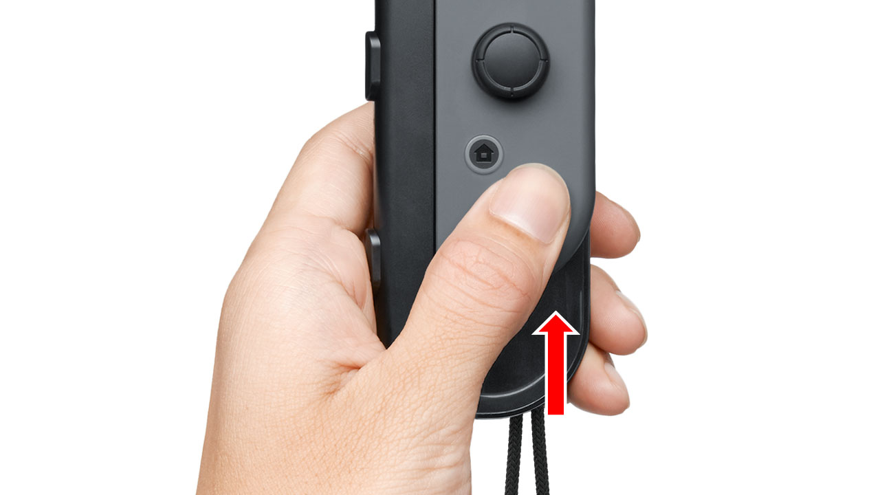 Continuing to hold the release button, slowly slide the Joy-Con upwards by 1 - 2 cm.